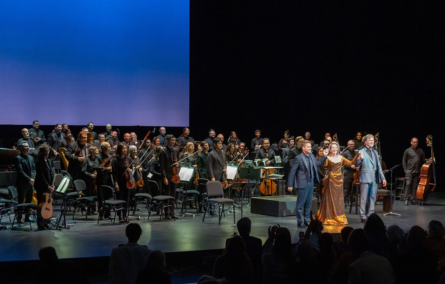 Conductor Robert Moody, soprano Renée Fleming, and baritone Rod Gilfry taking a bow with the Kansas City Symphony after The Brightness of Light, photo by Don Ipock