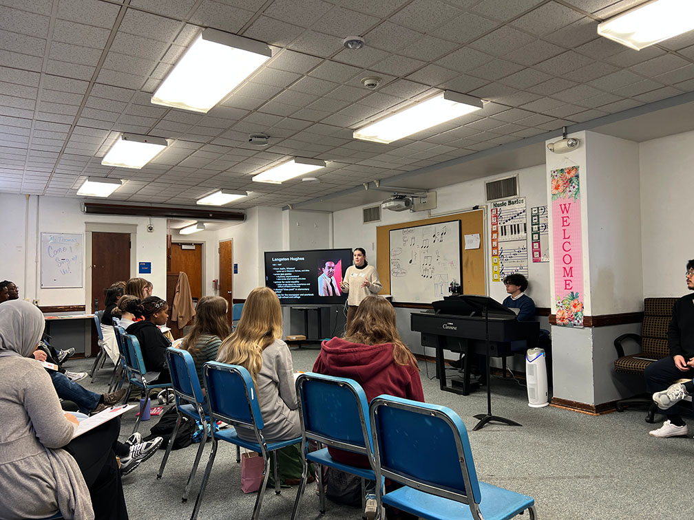 Manager of School Programs Emily Bridges giving presentation at a local school during a Residency Course