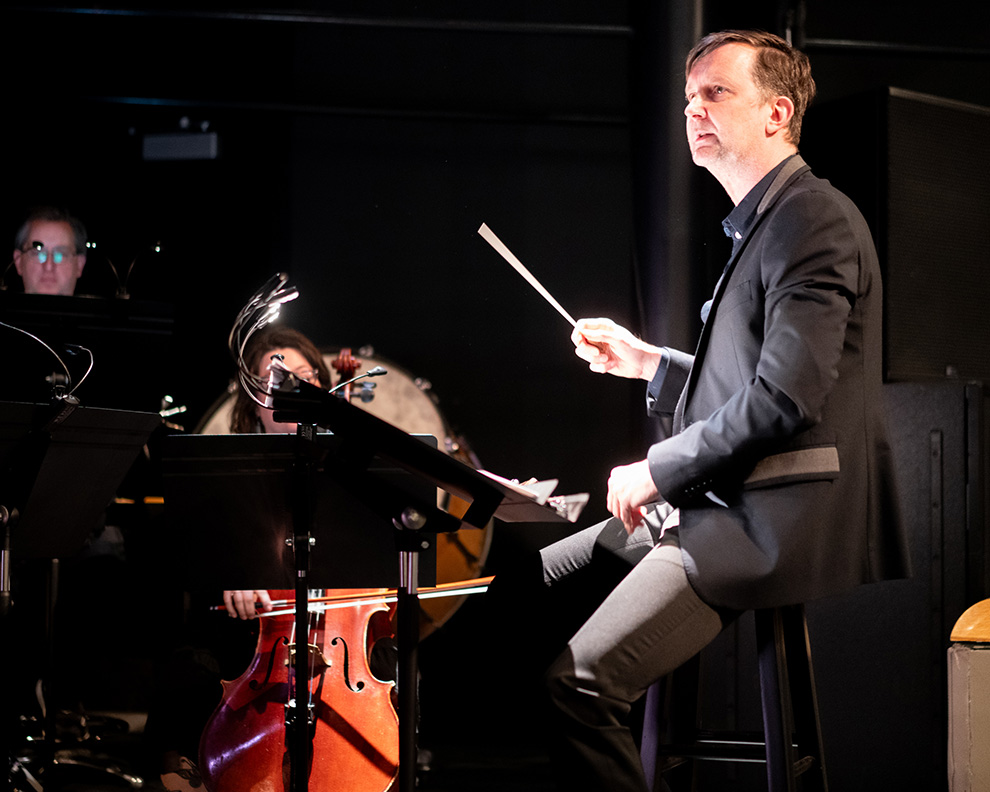 Piotr Wiśniewski conducting the newEar Contemporary Chamber Ensemble during Maya and the Magic Ring, photo by Andrew Schwartz
